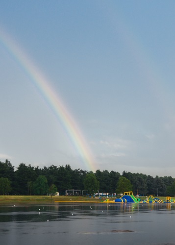 Playground for kids on the water with a rainbow