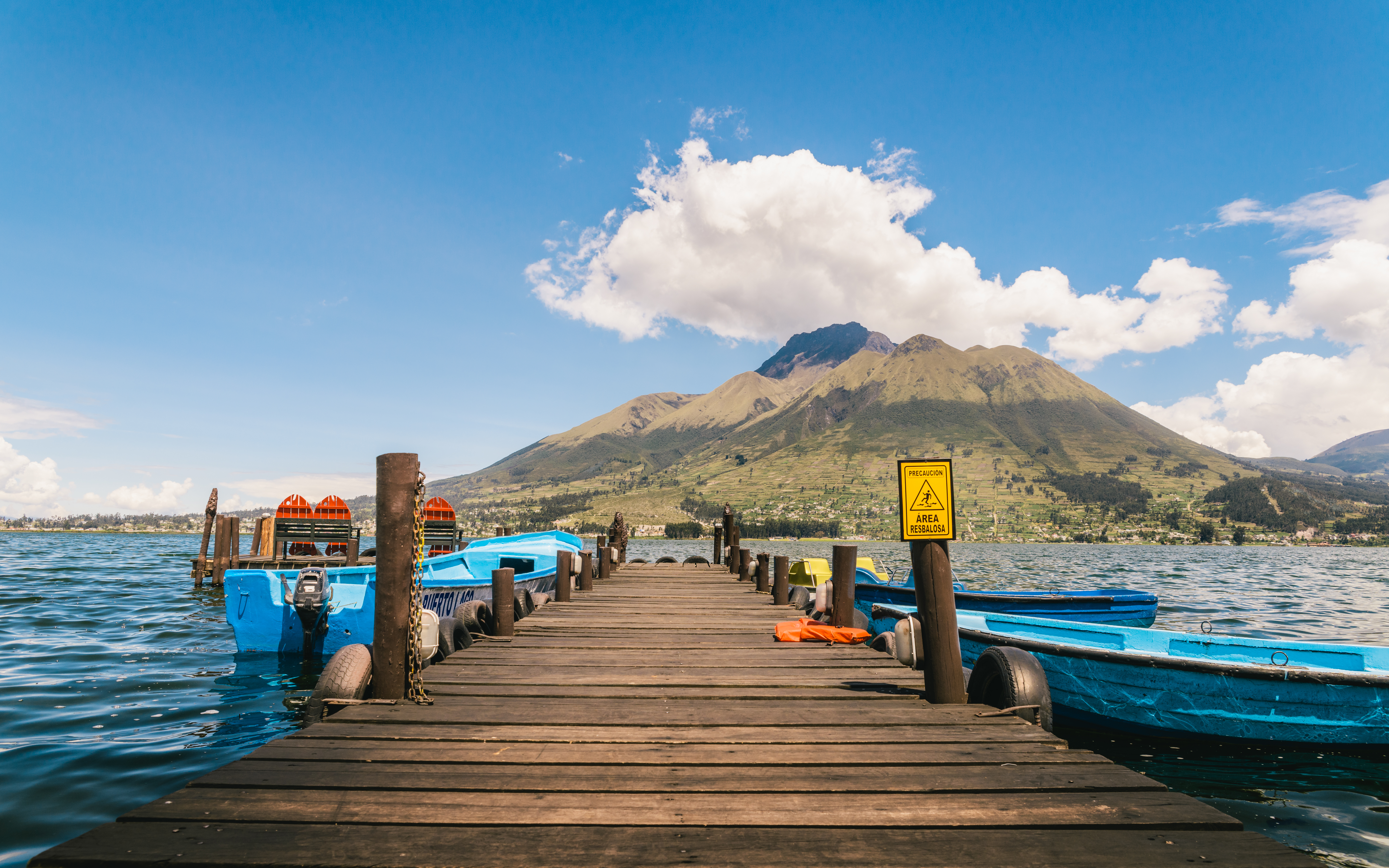 pier on lake with volcano