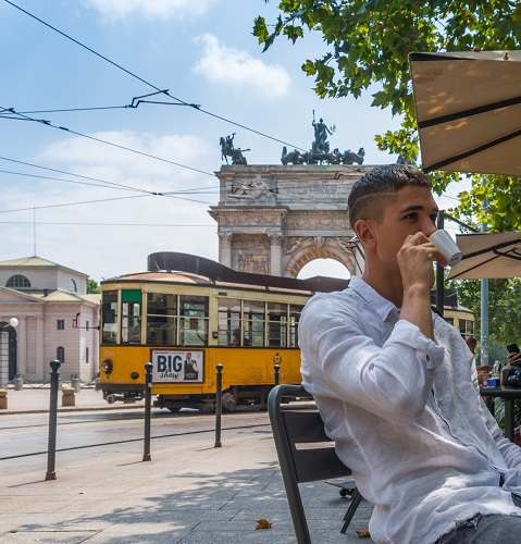 Young man drinking coffee in Milan, italy