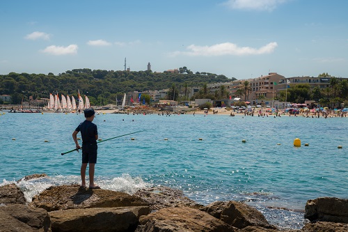 A young man fishes in Antibes, Cote d'azur, France