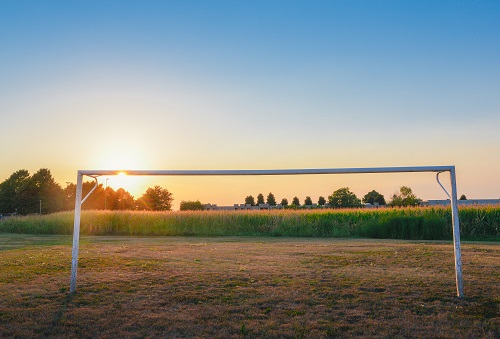 Empty football goal with sunlight and copy space