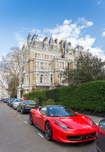 A red ferrari parked on a Kensington &amp; Chelsea Borough, London, UK street