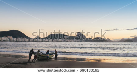 stock-photo-fishermen-at-dusk-in-copacabana-rio-de-janeiro-brazil-690133162