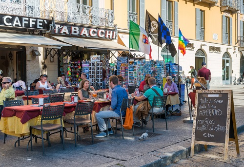 Aperitivo sign and tourists in Como, Italy