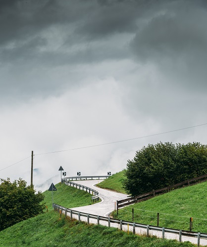 Swirving dangerous road on a hill during wet and bad weather conditions
