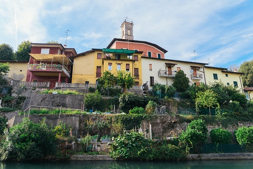 Colourful hillside buildings in Italy with vegetable gardens