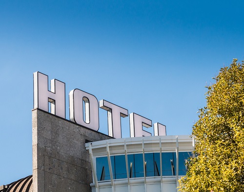 Close up of giant Hotel sign with blue sky