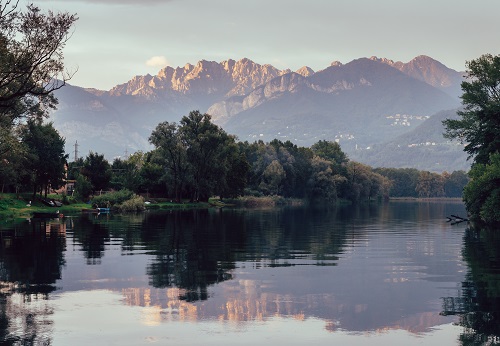 River Adda in northern Italy, close to Lake Como - reflection of Italian Alps