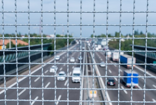 Narrow depth of field looking down from railing onto busy highway