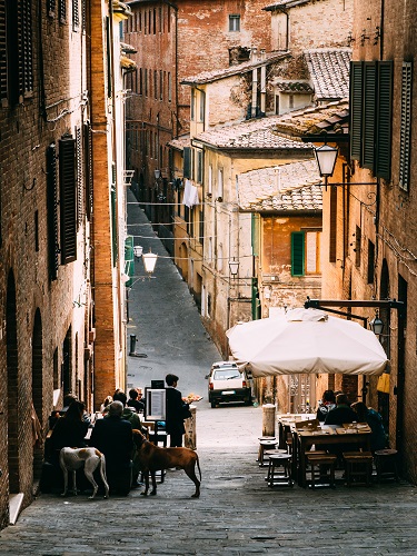 Small alleyway with quaint restaurant in Siena, Tuscany, Italy