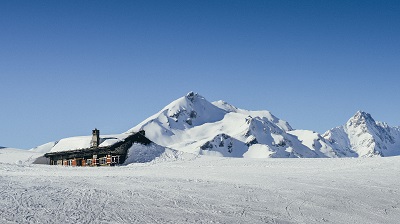 Wooden cabin in the Italian Alps during the winter, with copy sp
