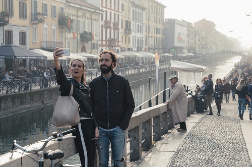 A couple take a selfie picture at Milan, Italy's Navigli Grande
