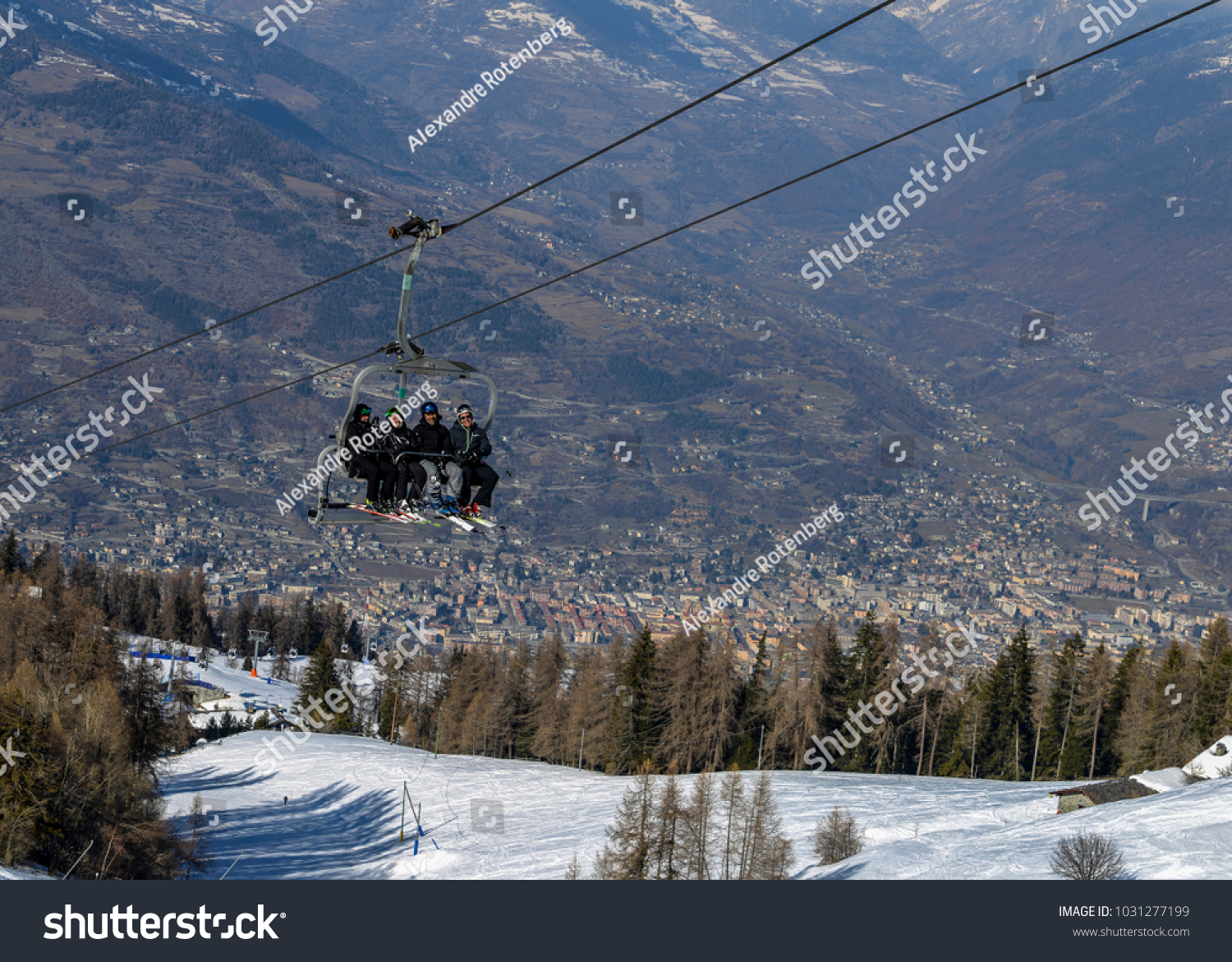stock-photo-pila-aosta-italy-feb-four-middle-aged-men-skiers-take-a-chair-lift-up-the-mountain-at-1031277199
