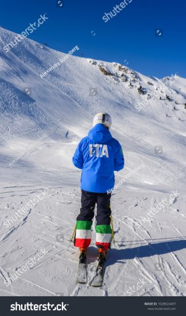 stock-photo-unidentifiable-female-skiier-from-behind-with-a-jacket-written-ita-which-is-short-for-italy-and-1028624497