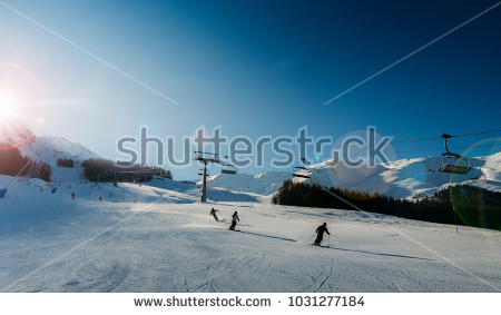 stock-photo-unidentifiable-skiers-at-ski-resort-in-pila-valle-d-aosta-italy-with-chairlift-and-mountain-1031277184