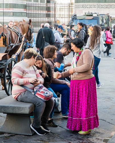 Gypsie woman successfully begs tourists in front of the Florence Cathedral in Tuscany, Italy
