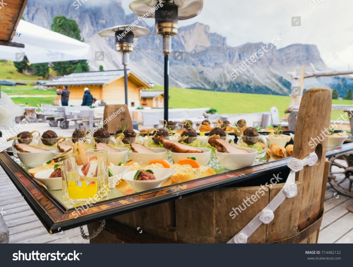 stock-photo-aperitivo-overlooking-the-dolomites-mountain-range-in-south-tyrol-northern-italy-714482122