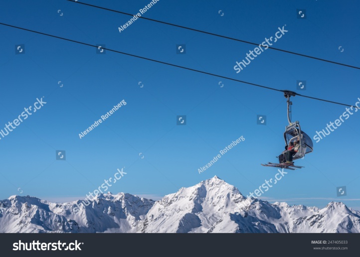 stock-photo-chair-lift-used-by-skier-in-winter-247405033