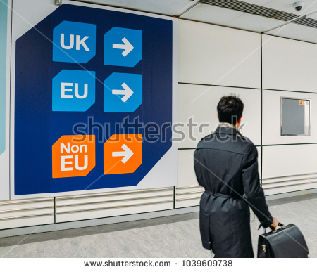 stock-photo-london-gatwick-march-nd-passenger-walks-past-sign-prior-to-immigration-control-pass-a-sign-1039609738