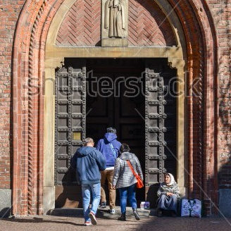 stock-photo-milan-italy-april-st-an-elderly-woman-begs-in-front-of-a-church-1069628645