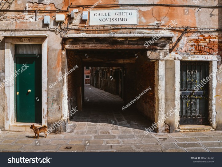 stock-photo-venice-italy-march-entrance-to-an-ancient-alleyway-in-the-traditional-jewish-ghetto-of-1062189461