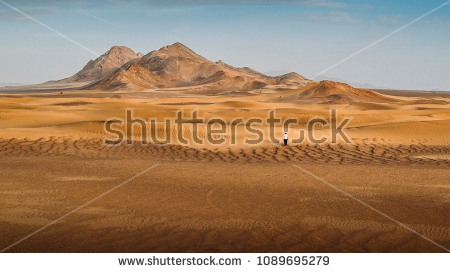 stock-photo-a-man-walking-alone-in-the-dasht-e-lut-a-large-salt-desert-located-in-the-provinces-of-kerman-1089695279