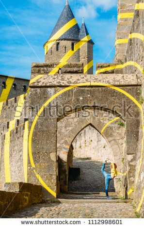 stock-photo-carcassonne-france-june-th-young-woman-performs-a-ballerina-move-at-the-cobbled-1112998601