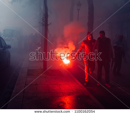 stock-photo-paris-france-may-protestors-wearing-a-guy-fawkes-mask-light-gas-canisters-to-express-1100162054