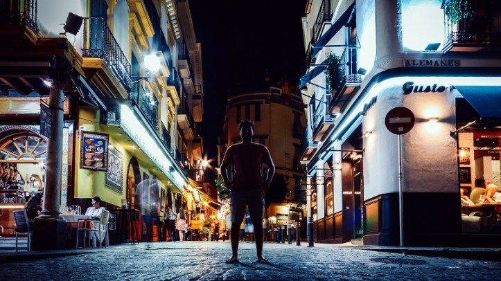 Tourists relaxing at terraces of traditional tapas bars at during in the historic centre of Seville, Andalusia, Spain