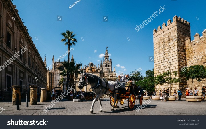 stock-photo-seville-spain-sept-touristic-horse-drawn-carriage-overlooking-giralda-tower-at-seville-1501898783