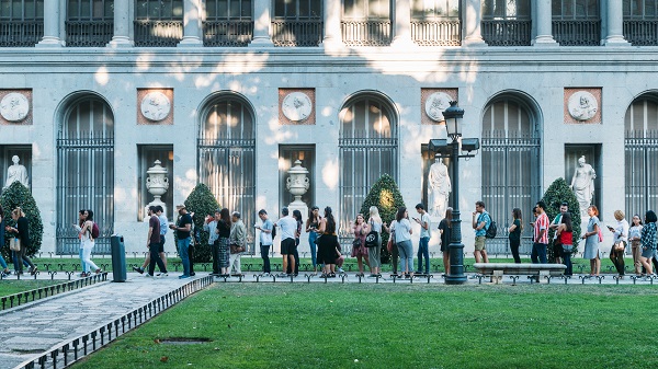 Tourists queue at the entrance of the Prado Museum in Madrid, Spain
