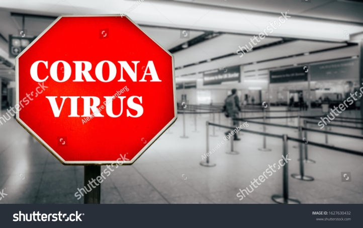 stock-photo-coronavirus-written-on-stop-sign-with-passengers-arriving-at-passport-control-within-generic-1627630432
