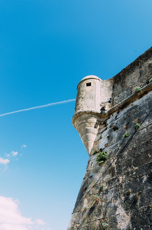 Detail of the old rampart wall and watchtower of the 16th century Citadel of Cascais Portugal with modern surveillance