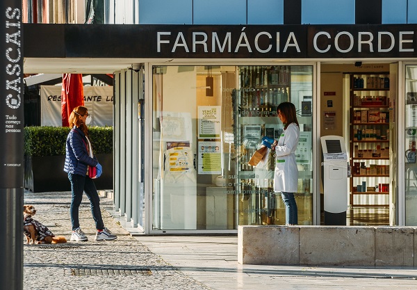 Customer and pharmacist outside a pharmacy in Cascais, Portugal during the Coronavirus Covid-10 epidemic