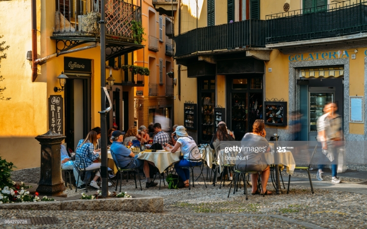 Bellagio, Italy - April 26, 2018: Tourists sitting at a cafe