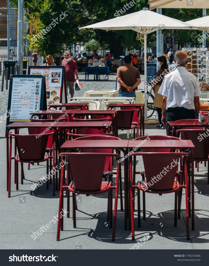 stock-photo-lisbon-portugal-august-waiters-standing-in-front-of-empty-restaurant-terraces-waiting-1793218486